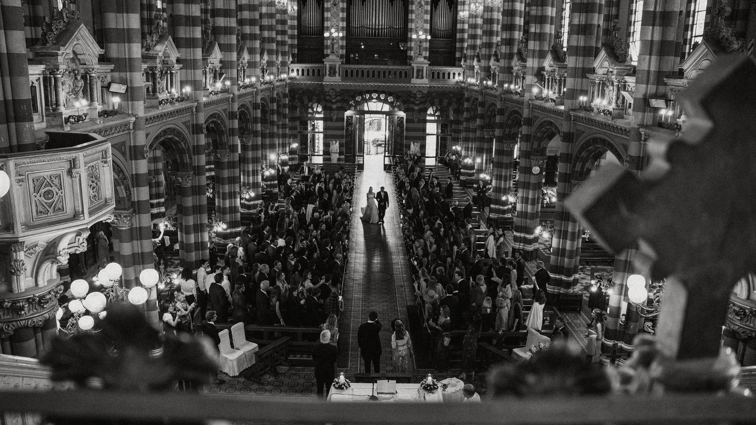A black and white panoramic collage shows busy urban street scenes with buildings, crowds, and traffic in motion.