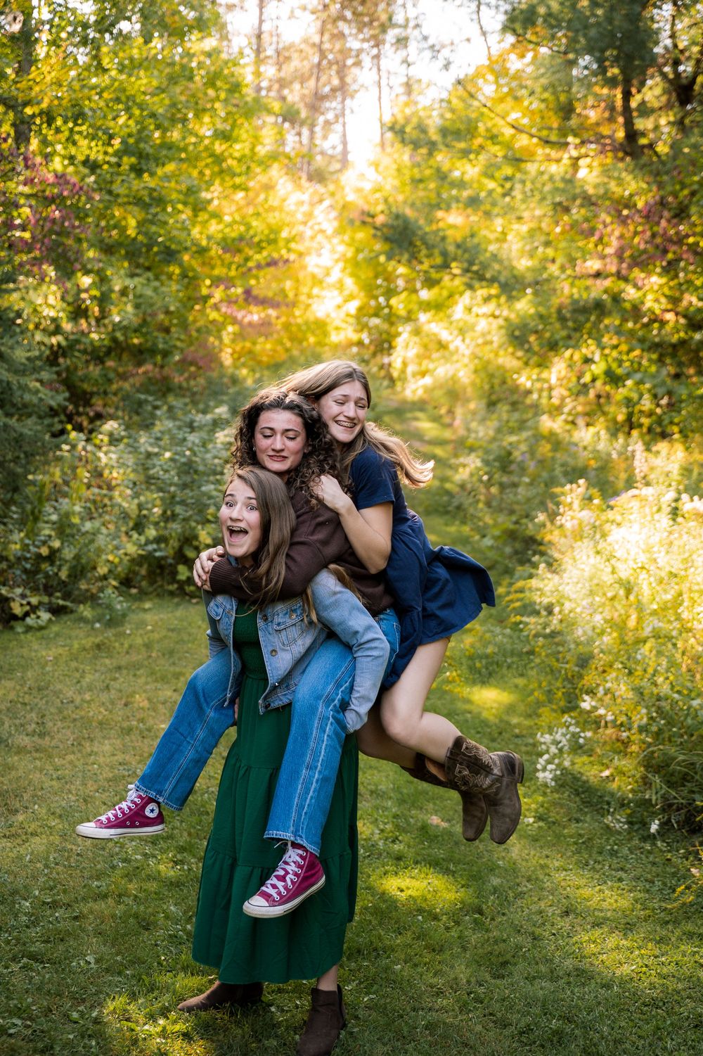 A playful moment captured in golden sunlight as two people share laughter and joy in a lush green outdoor setting.