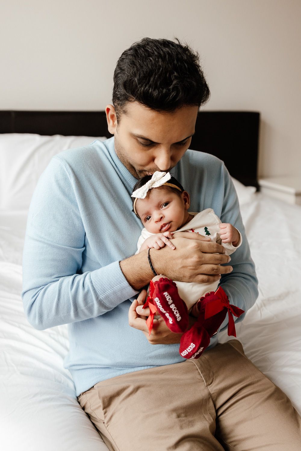 A dad kisses his new baby's head in San Jose