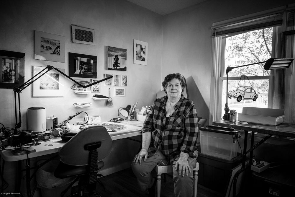 A black and white photo montage showing multiple interior office or workspace scenes with desks and equipment.