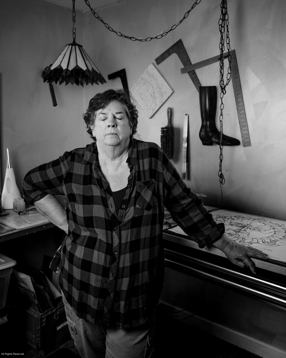 Black and white panoramic sequence showing someone in plaid shirt sitting at piano in dimly lit room.