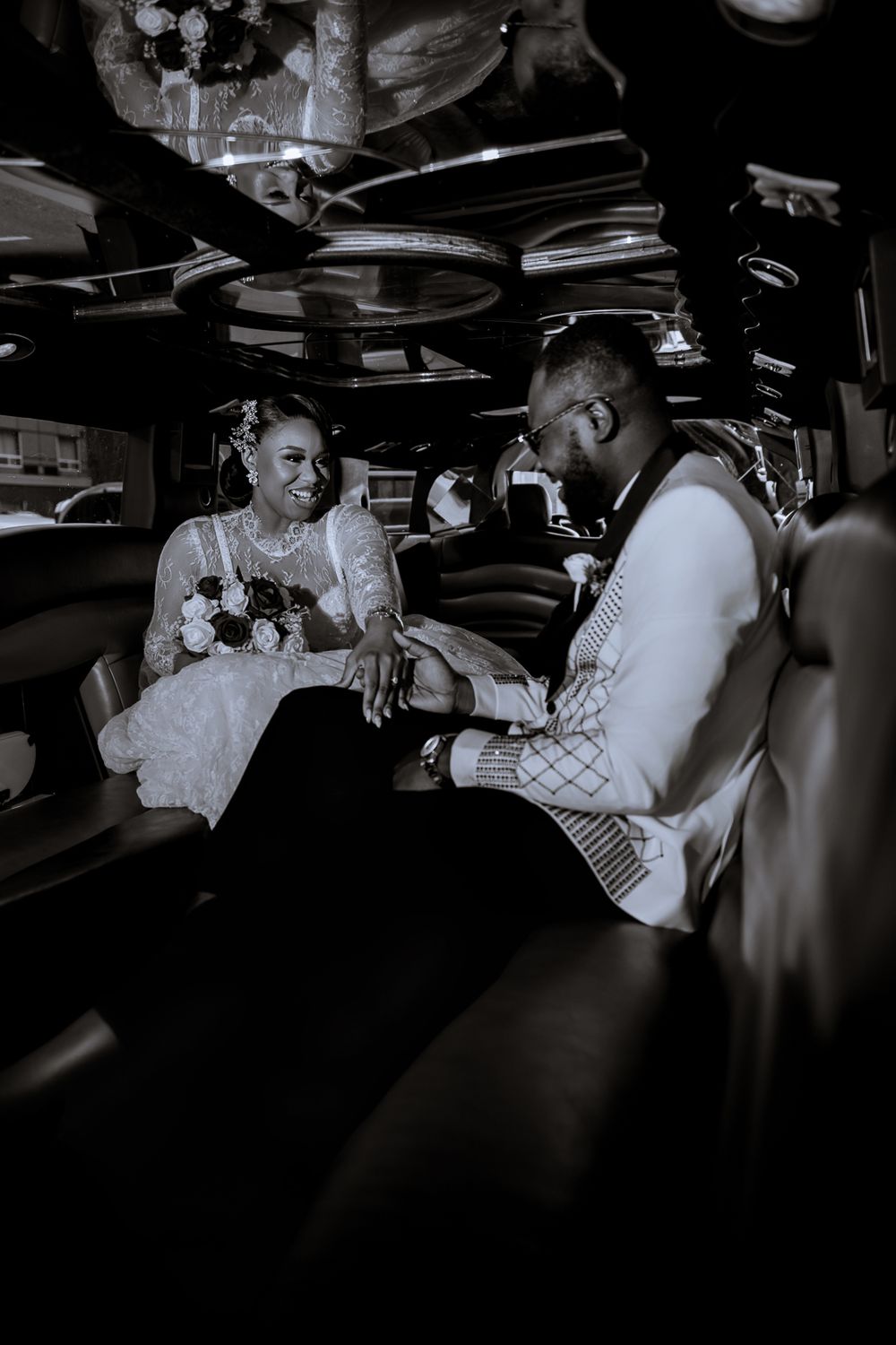 Romantic black and white photo series of a tender couple sharing intimate moments together in a dimly lit setting.