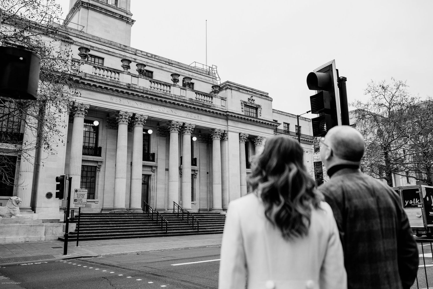 Vintage black and white photographs of a classic building facade with columns and architectural details.
