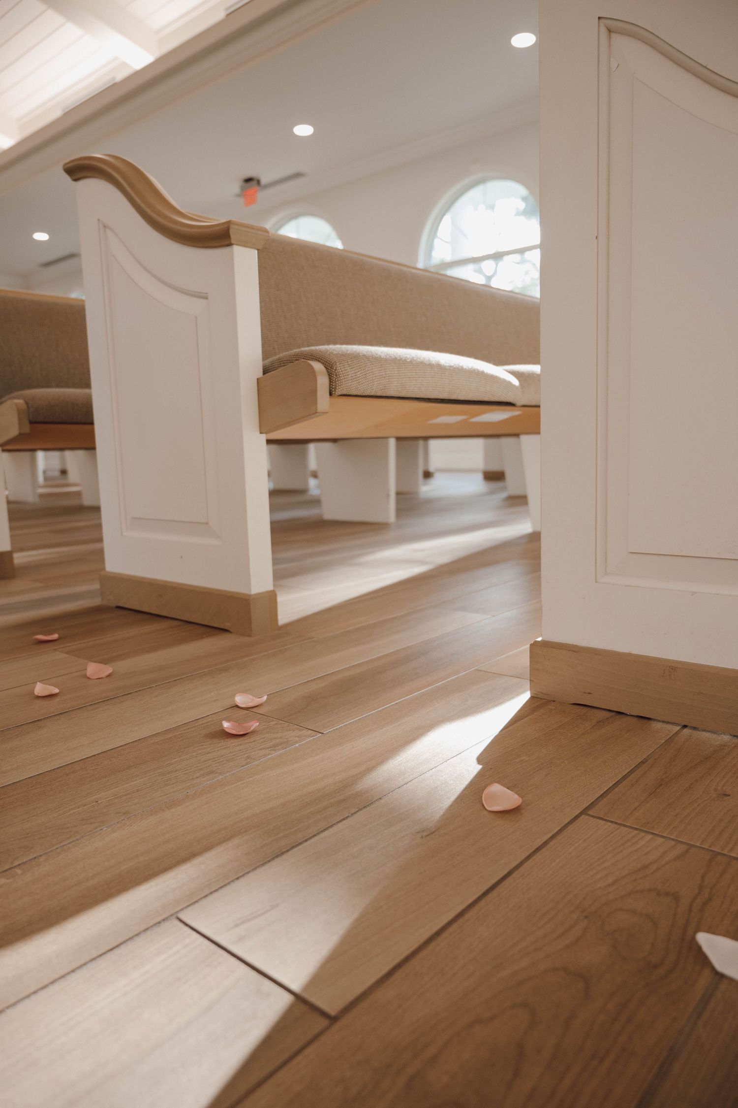 Wooden church pews and flooring shown in sequence with natural light streaming through windows.