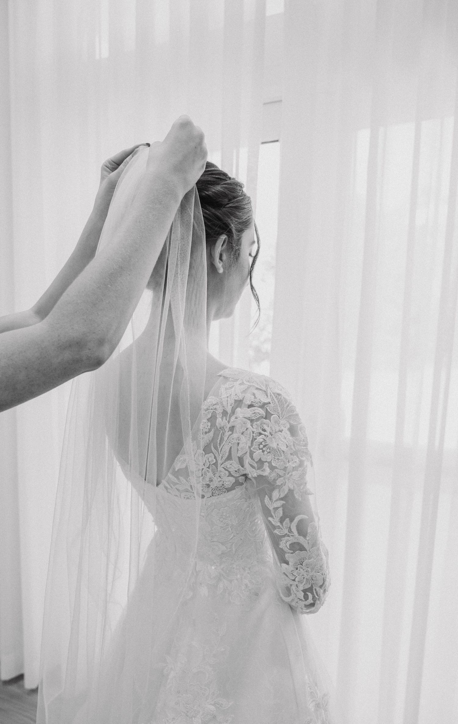 A series of photos showing the final adjustments being made to a bride's delicate lace veil.