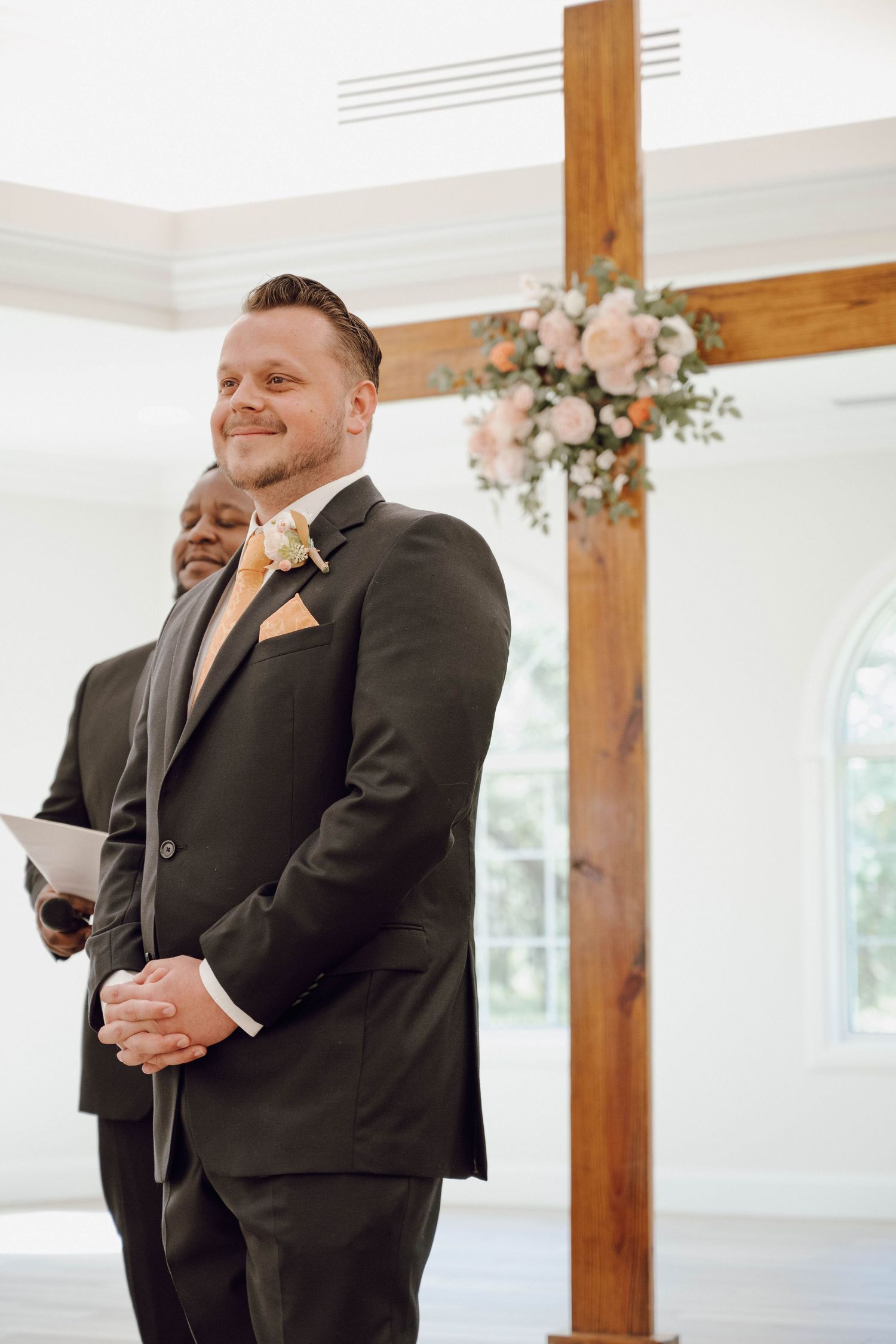 Wedding ceremony candid moments showing emotions in a bright indoor venue with wooden beams.