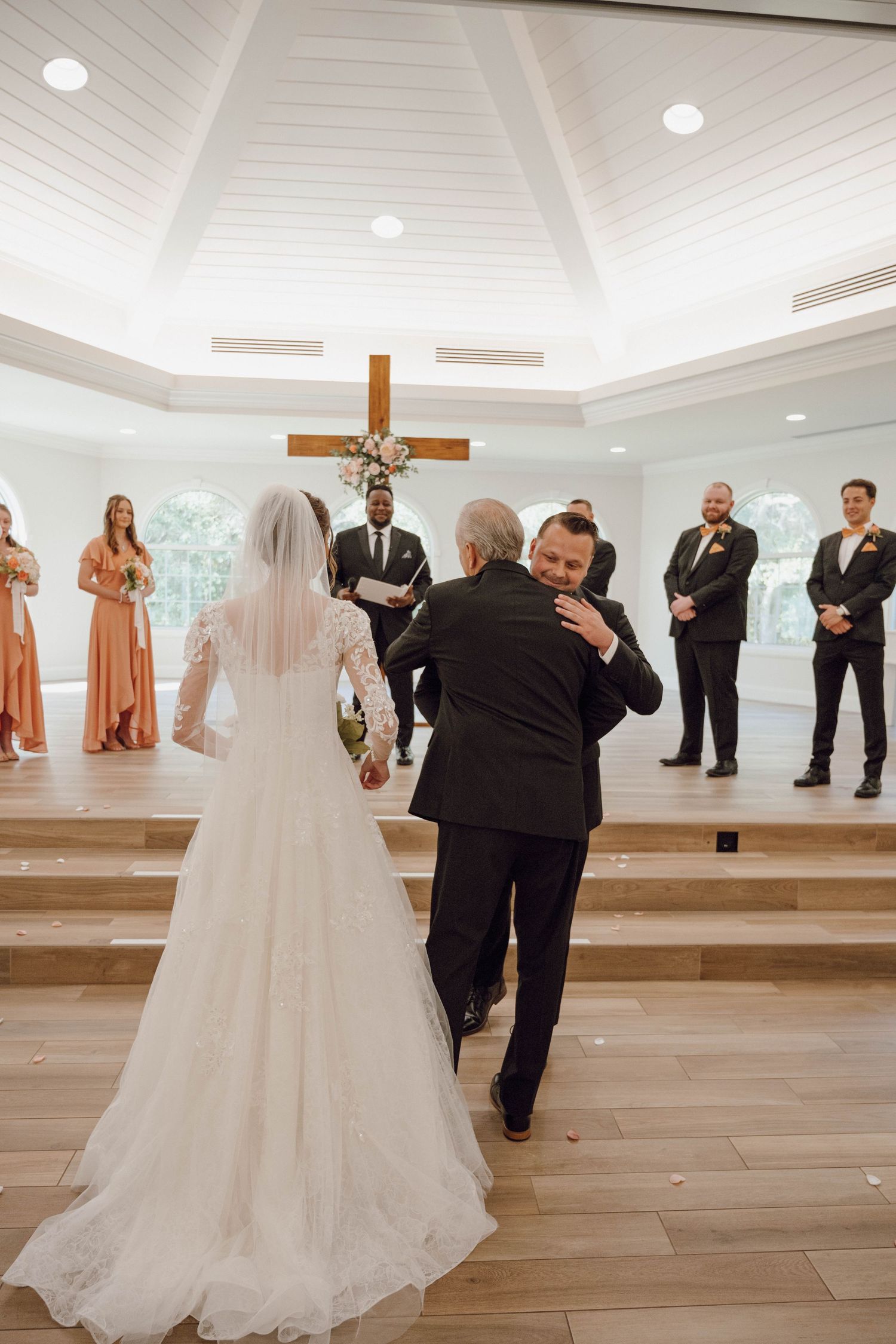 Wedding ceremony sequence showing first look moments in a bright chapel setting.
