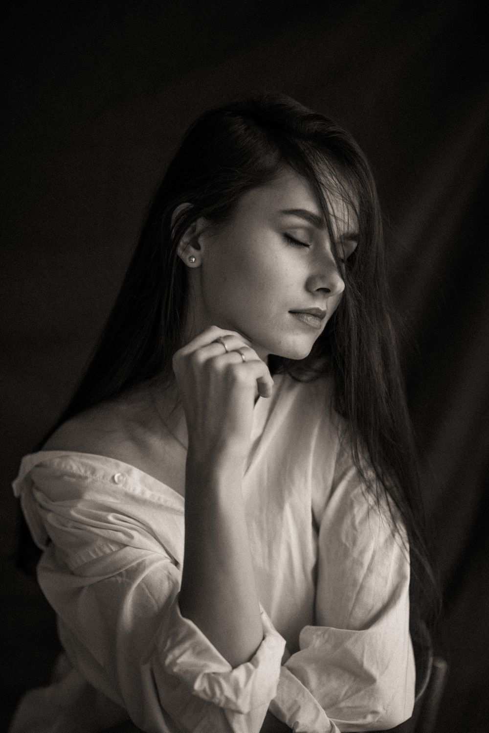 Artistic black and white portrait series showing a figure in a white blouse with dramatic shadows and lighting.