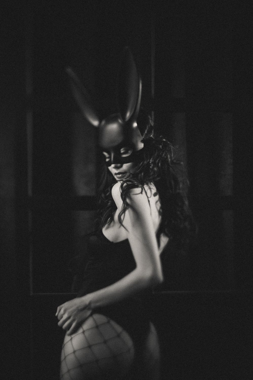 A dramatic black and white artistic photo series showing intimate silhouettes in low light conditions.
