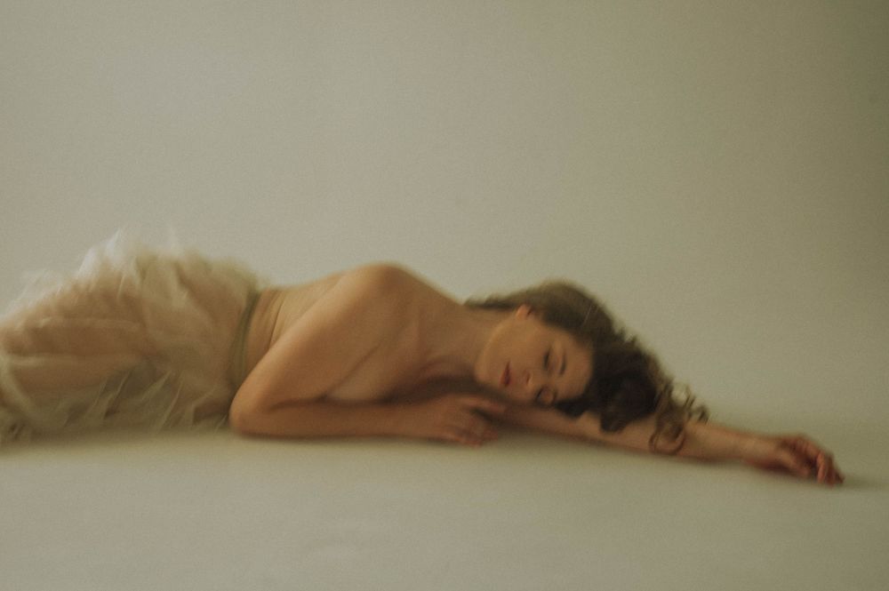 A series of artistic nude photographs showing a reclining figure against neutral backgrounds in soft lighting.