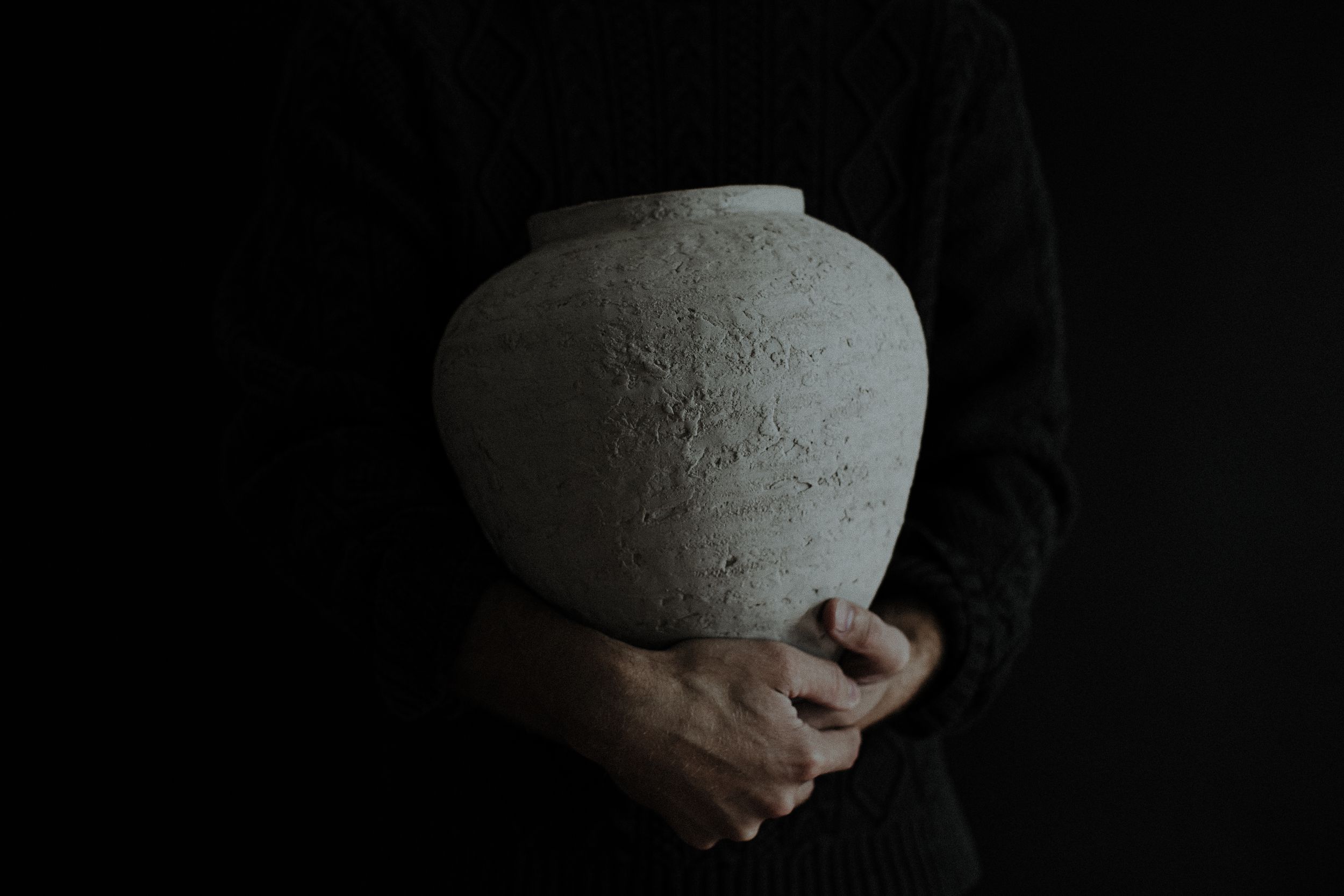 A collection of dark and moody artistic photographs arranged in a horizontal row showing abstract shapes and textures.