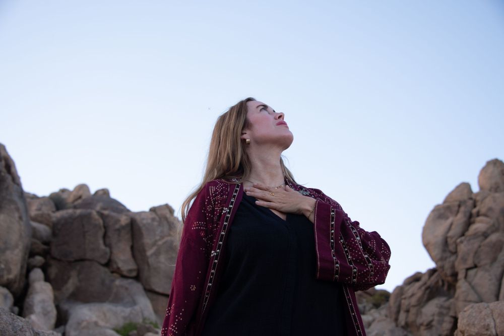 Artistic portrait photography for women in Joshua Tree, focused on presence, self-witnessing, and natural desert light. Grounded, intentiona
