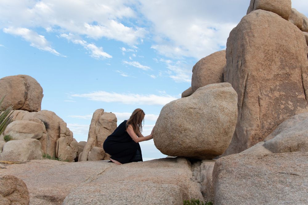 Artistic portrait photography for women in Joshua Tree, focused on presence, self-witnessing, and natural desert light. Grounded, intentiona