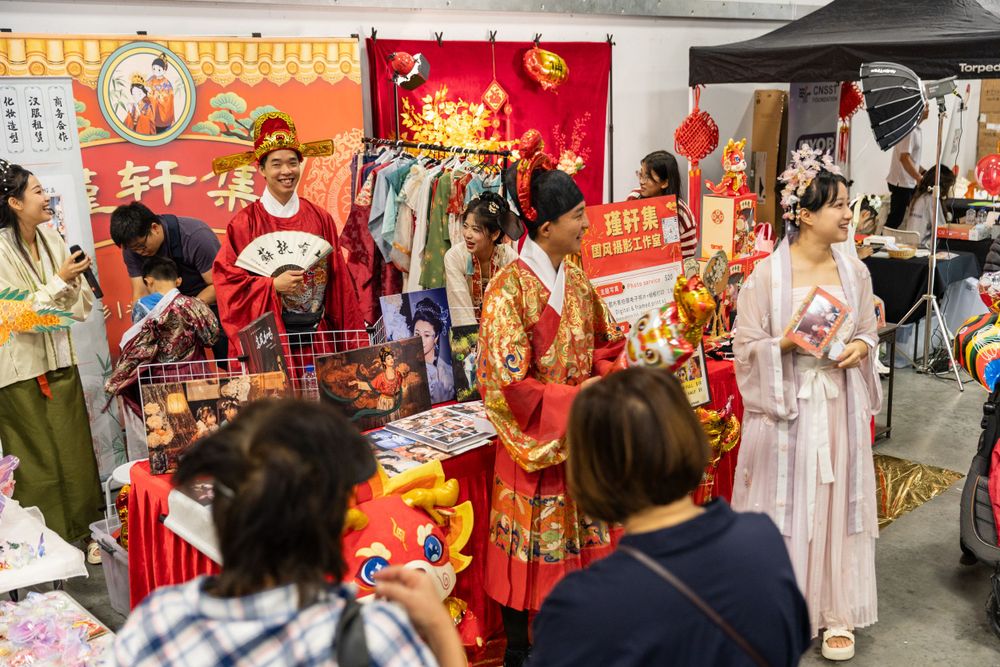 Lively New Year Hanfu market stall event photography capturing cultural portraits and interactions, by an Auckland photographer.