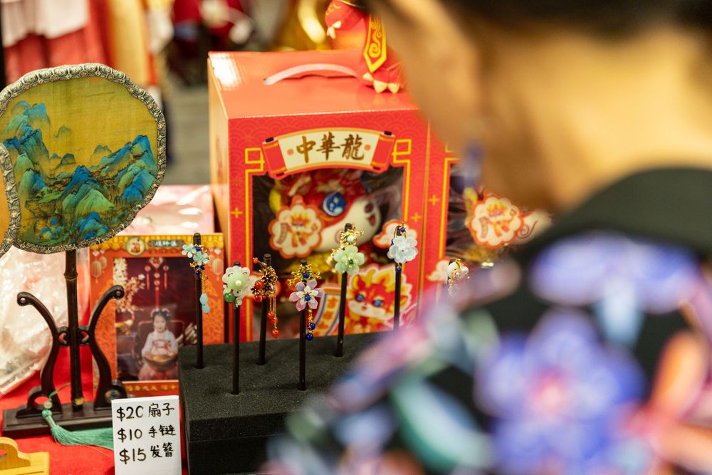 Lively New Year Hanfu market stall event photography capturing cultural portraits and interactions, by an Auckland photographer.