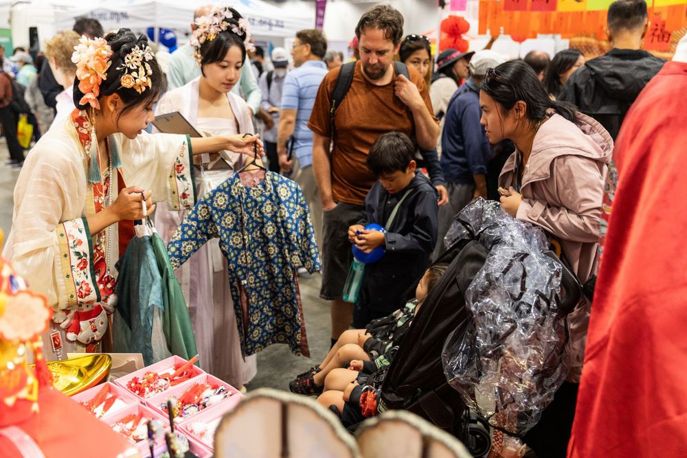 Lively New Year Hanfu market stall event photography capturing cultural portraits and interactions, by an Auckland photographer.