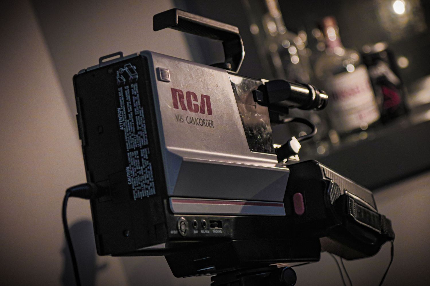 Vintage RCA professional television camera mounted on a tripod in low light conditions.
