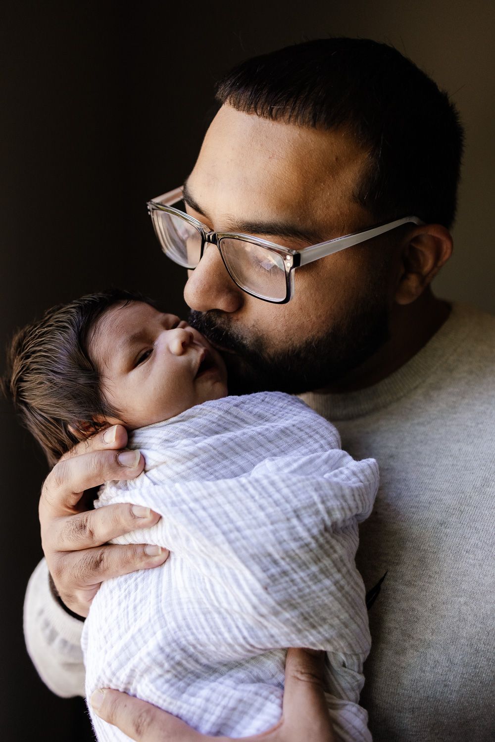 Dad kisses baby at San Jose in-home newborn photo session by San Jose Newborn Photographer Cindy Tucey Photography
