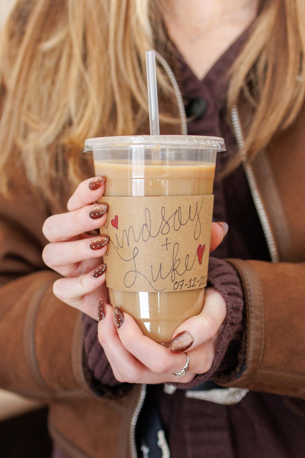 A series of photos showing hands holding an iced coffee drink in a clear plastic cup with writing on it.