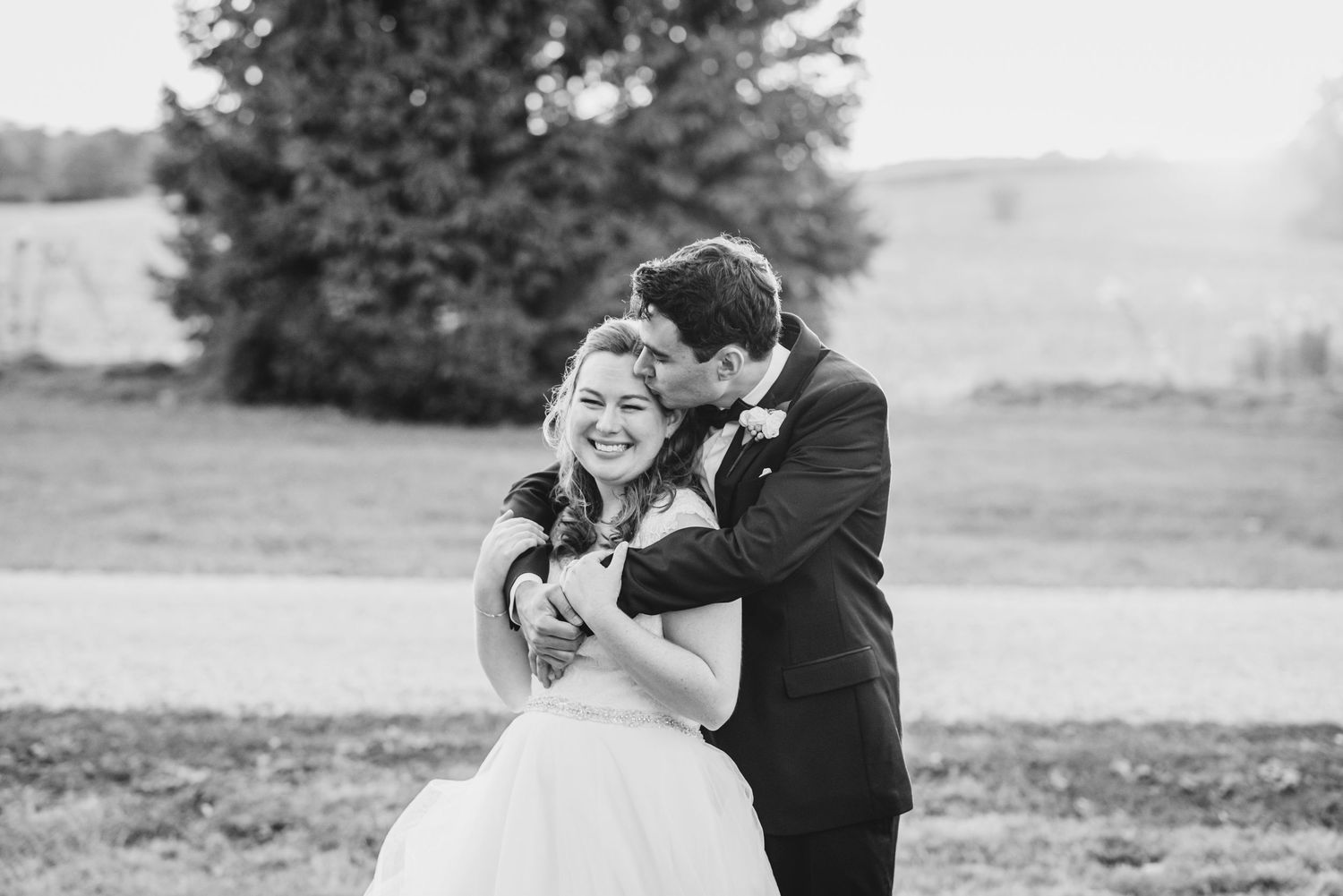 A black and white photo series of a couple dancing together outdoors in formal wedding attire.