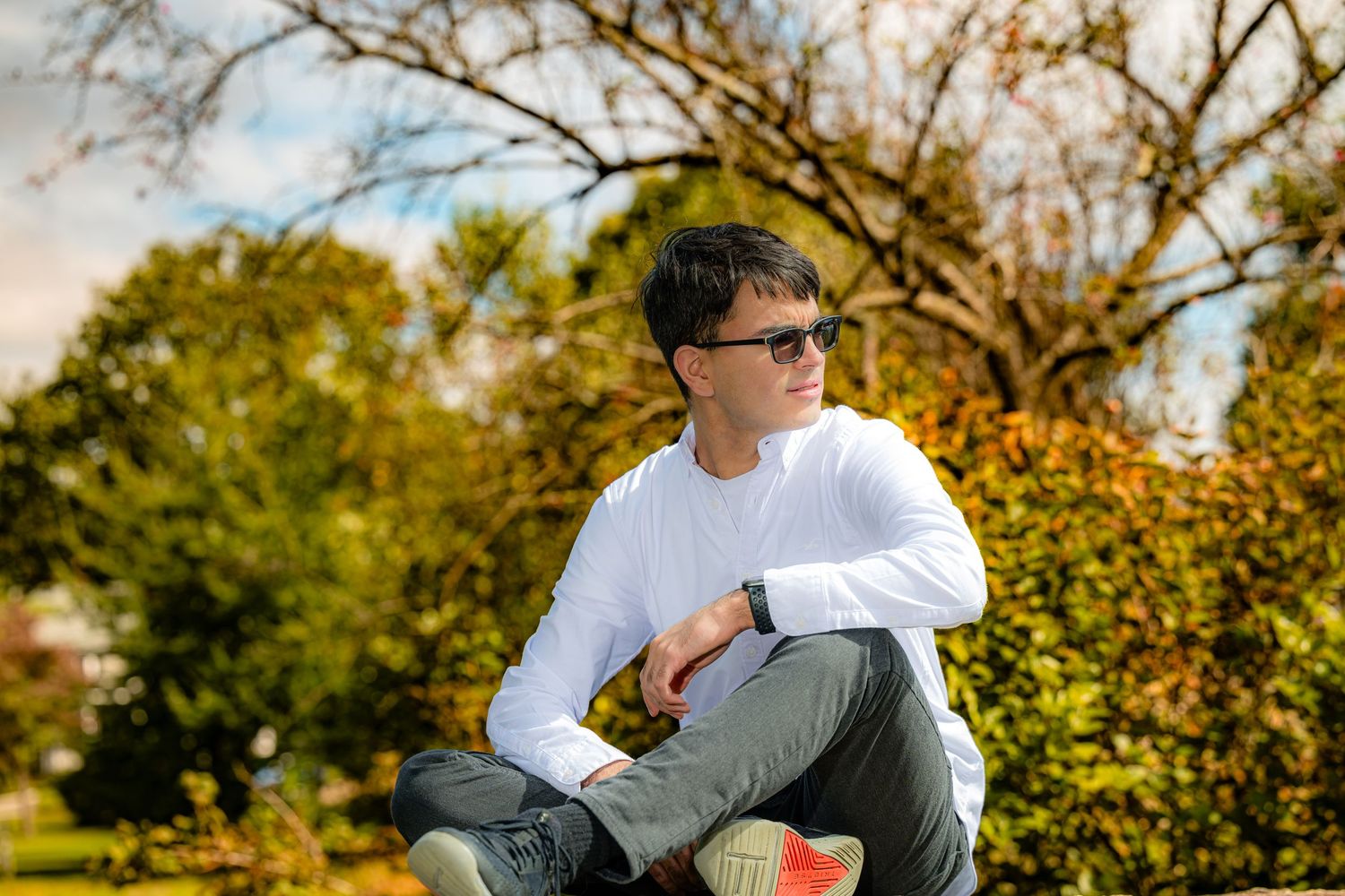 Stamford High School senior portrait session in a natural park setting with professional retouching and vibrant colors.