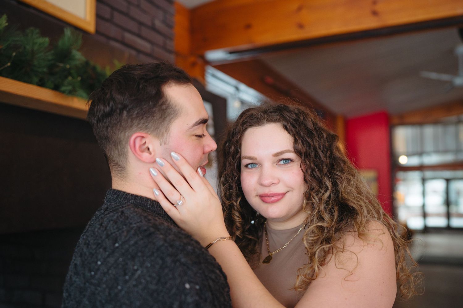 A romantic indoor engagement photo session showing tender moments between a couple.