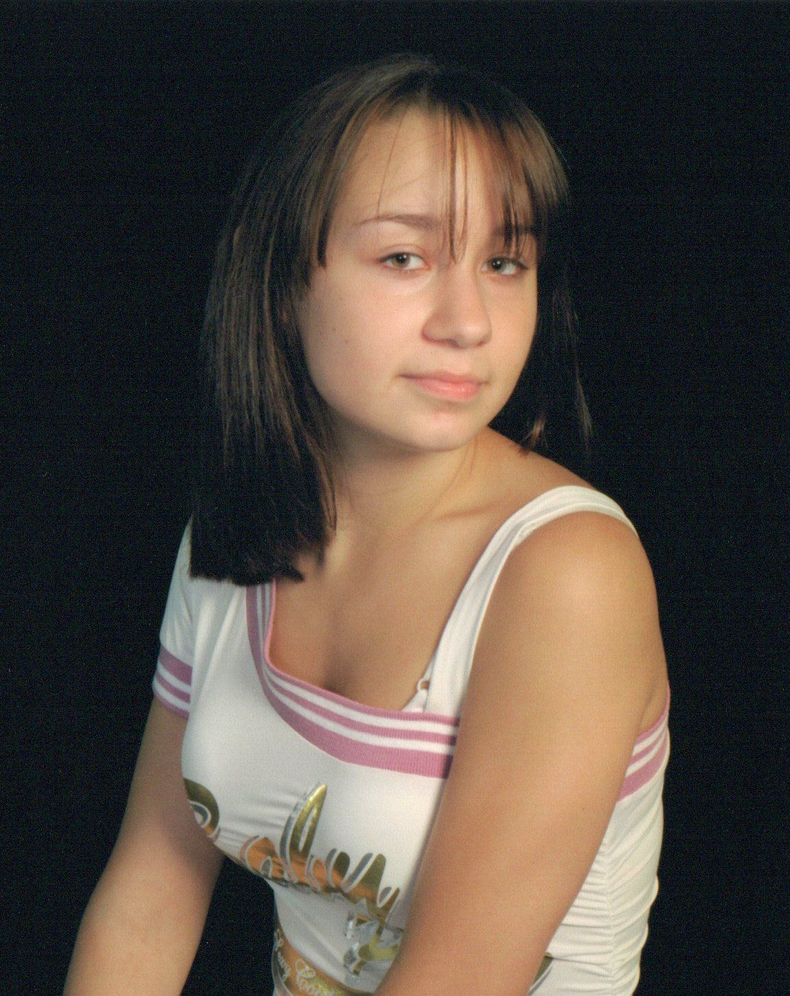 A person in a white tank top poses against a dark background in a series of connected portrait shots.