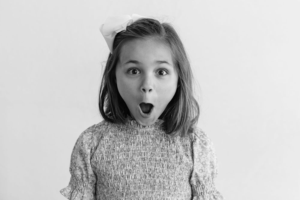 A sequence of four black and white photos showing someone making silly expressions and faces.