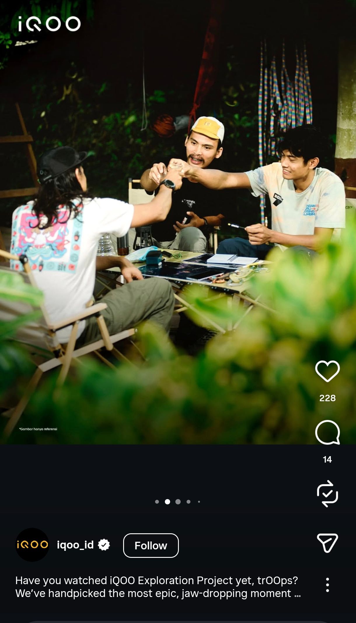People relaxing outdoors on wooden benches while using mobile devices in a garden setting.