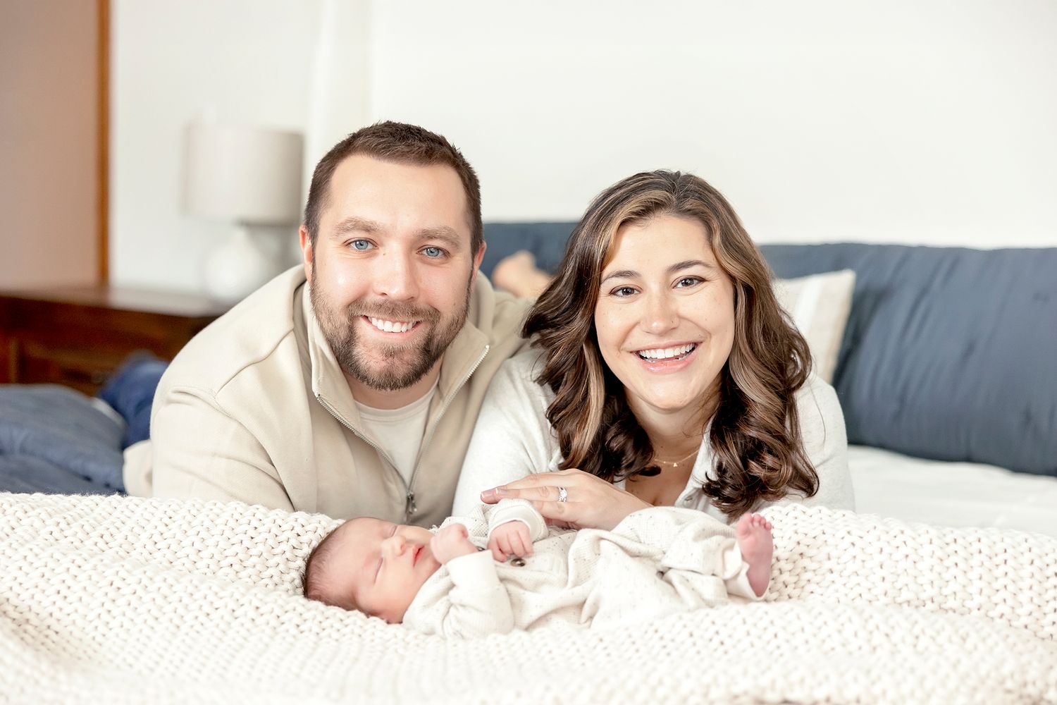Newborn photography session in Clear Lake Iowa featuring sleeping newborn wrapped in soft blanket during in-home session