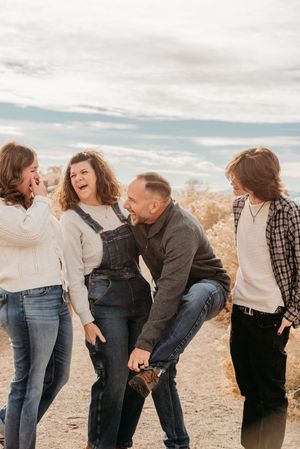 A sequence of candid photos showing a family laughing together outdoors on a cloudy day.