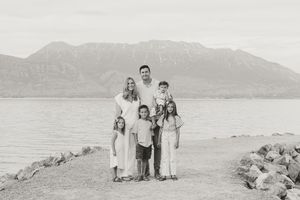 A collection of vintage black and white photographs showing people posing near mountains and coastal landscapes.
