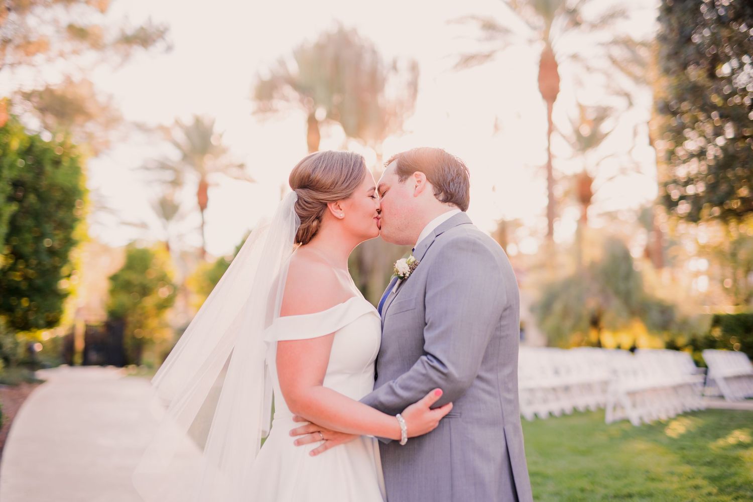 Black and white wedding photos showing a bride in a flowing white dress with a long veil in an elegant hallway setting.