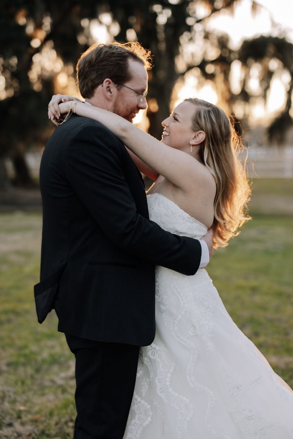 A romantic sunset wedding photo series showing a couple embracing and dancing outdoors under trees.