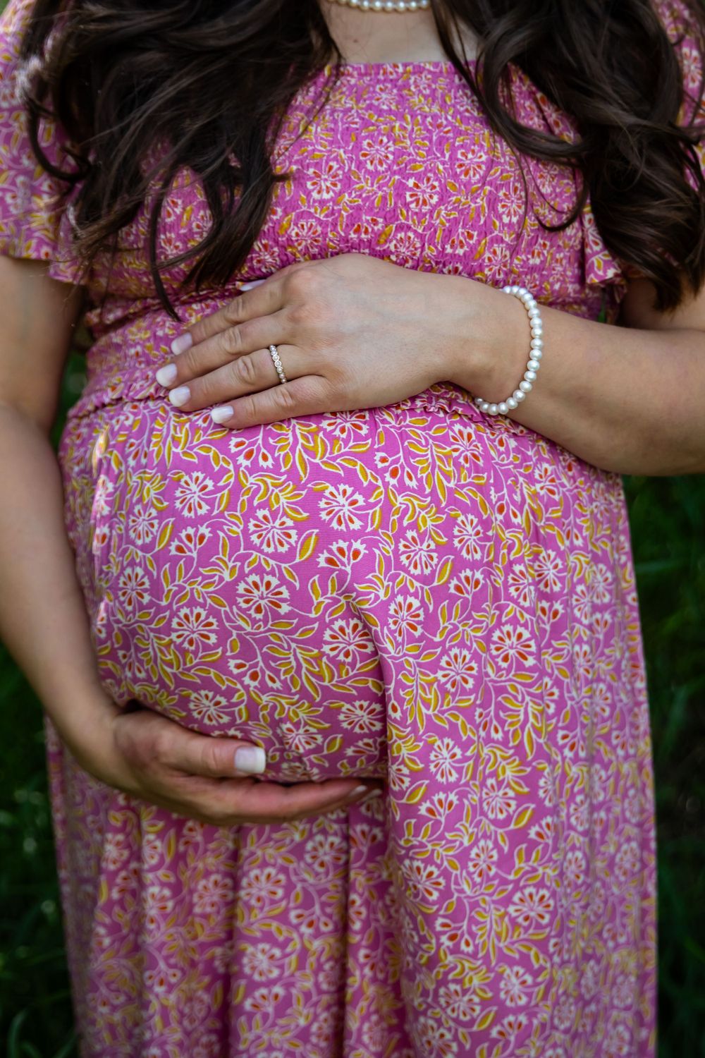 a pregnant woman holding her baby bump.
