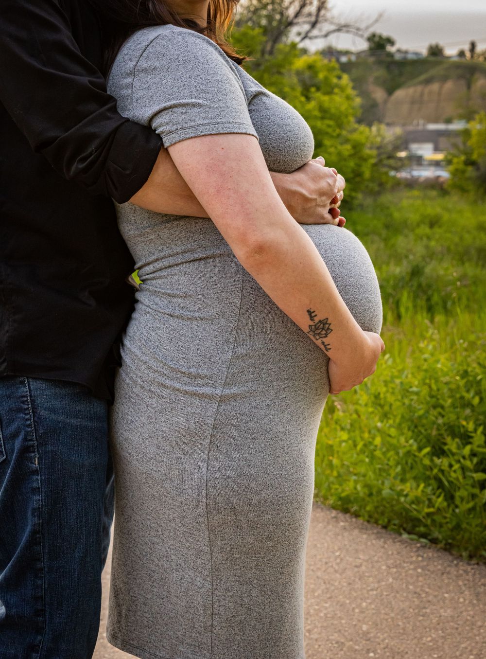 a pregnant woman holds her baby bump.