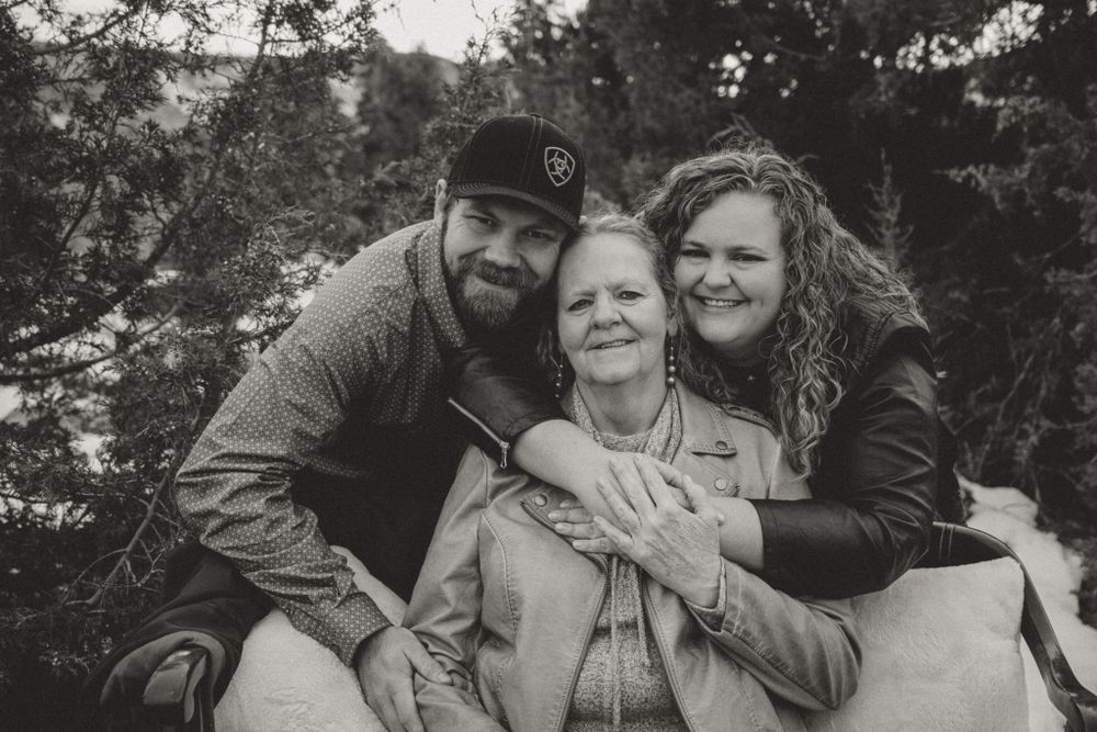 Black and white portrait capturing intimate family moments and genuine emotions outdoors.