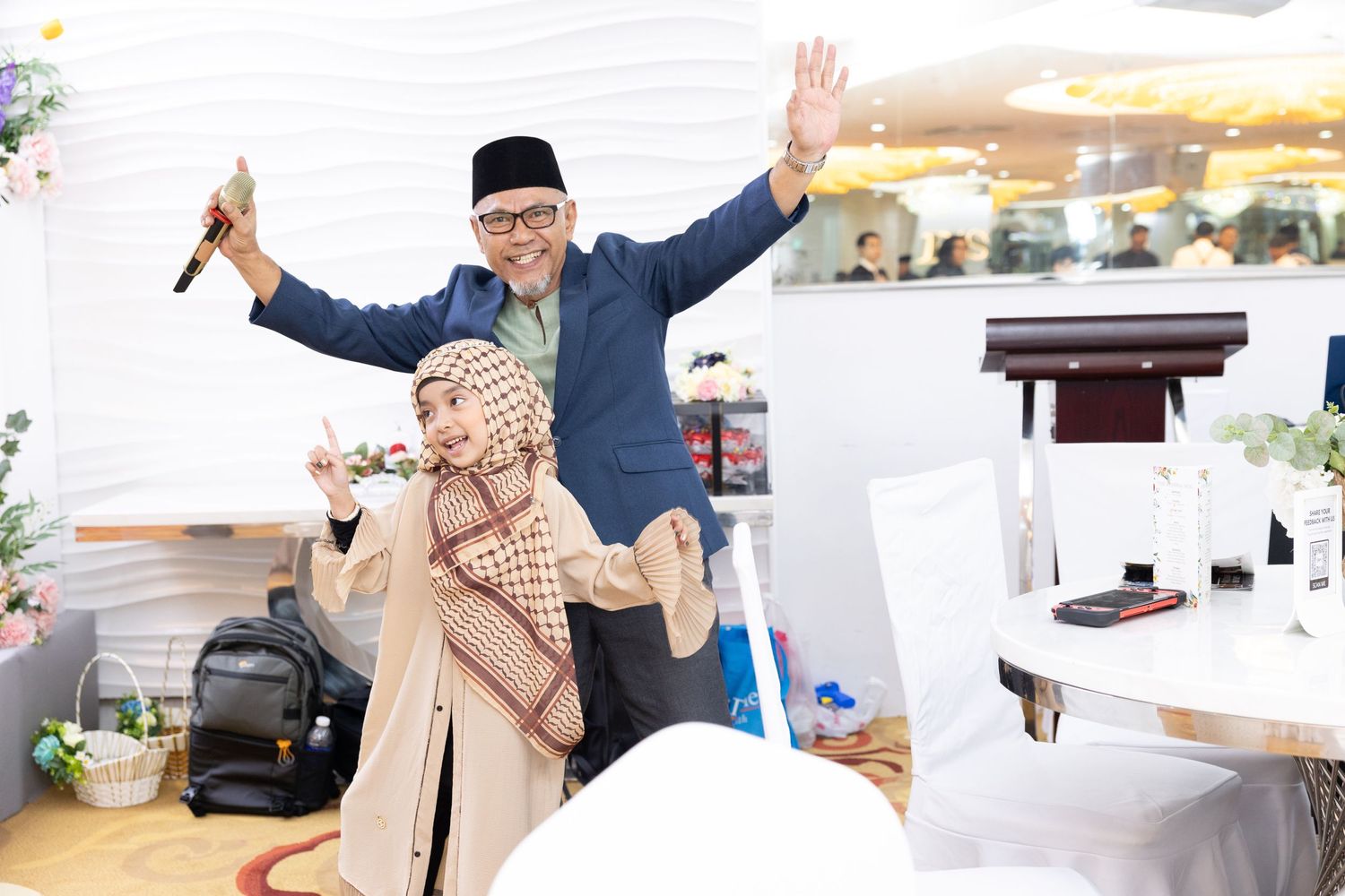 A joyful celebration moment captured at a wedding reception with guests showing excitement.