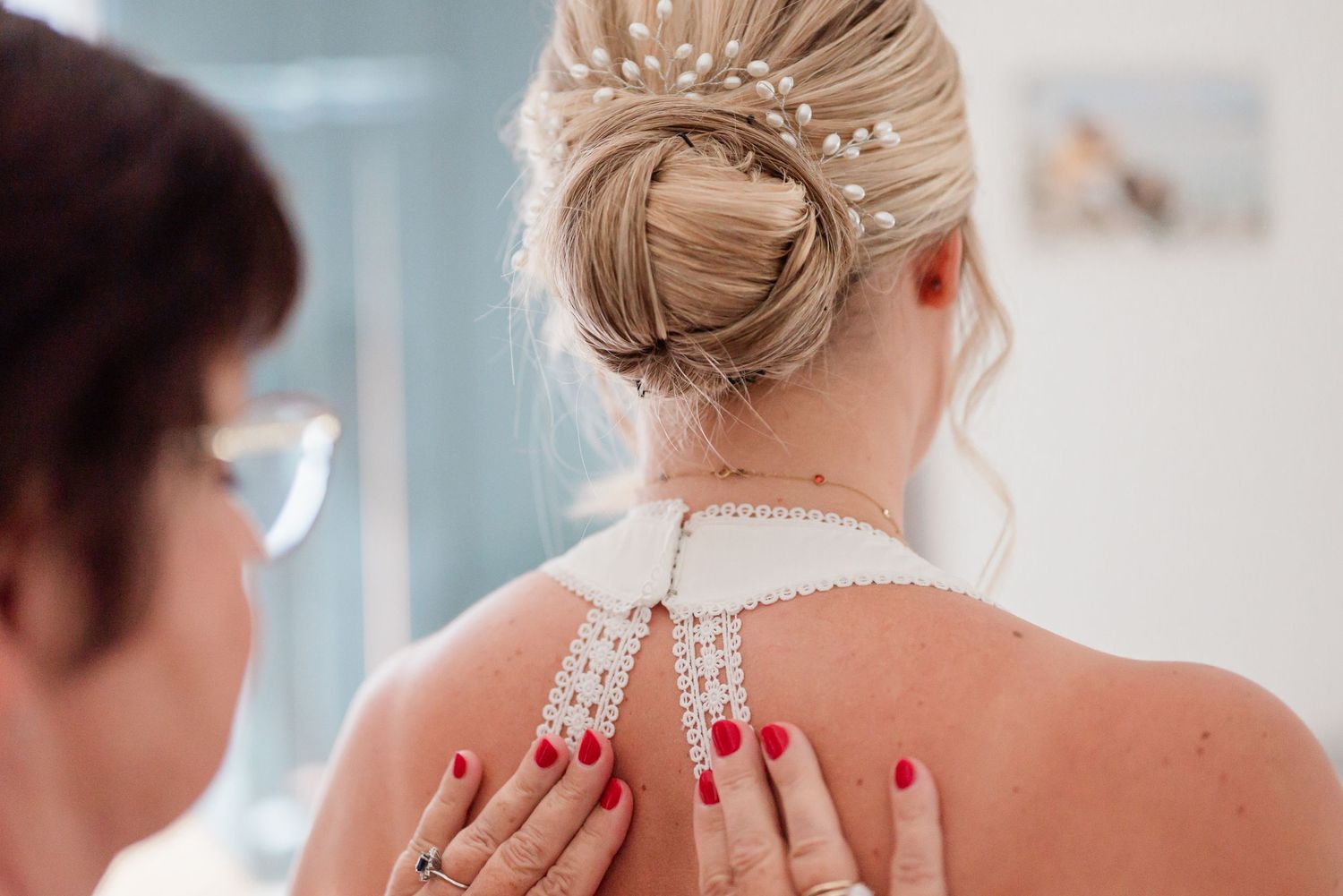 Mother of bride fixing the backside of the Bride's wedding dress in Geneva, Switzerland before the civil ceremony