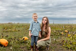 mom and son in a pumpkin field