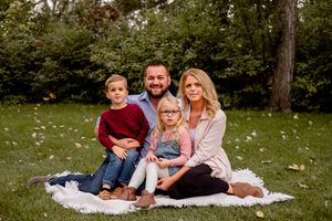 family of four sitting on blanket