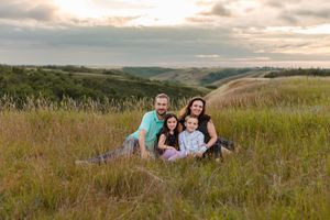 family of four with beautiful valley in background
