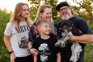family of four with their dog
