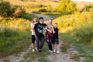 family of four laughing