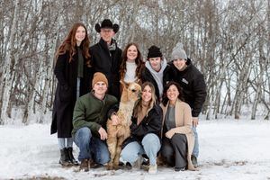 winter scene of family and alpaca