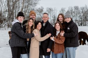 blended family embrace in winter pasture