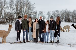 blended family session with alpacas in a winter scene