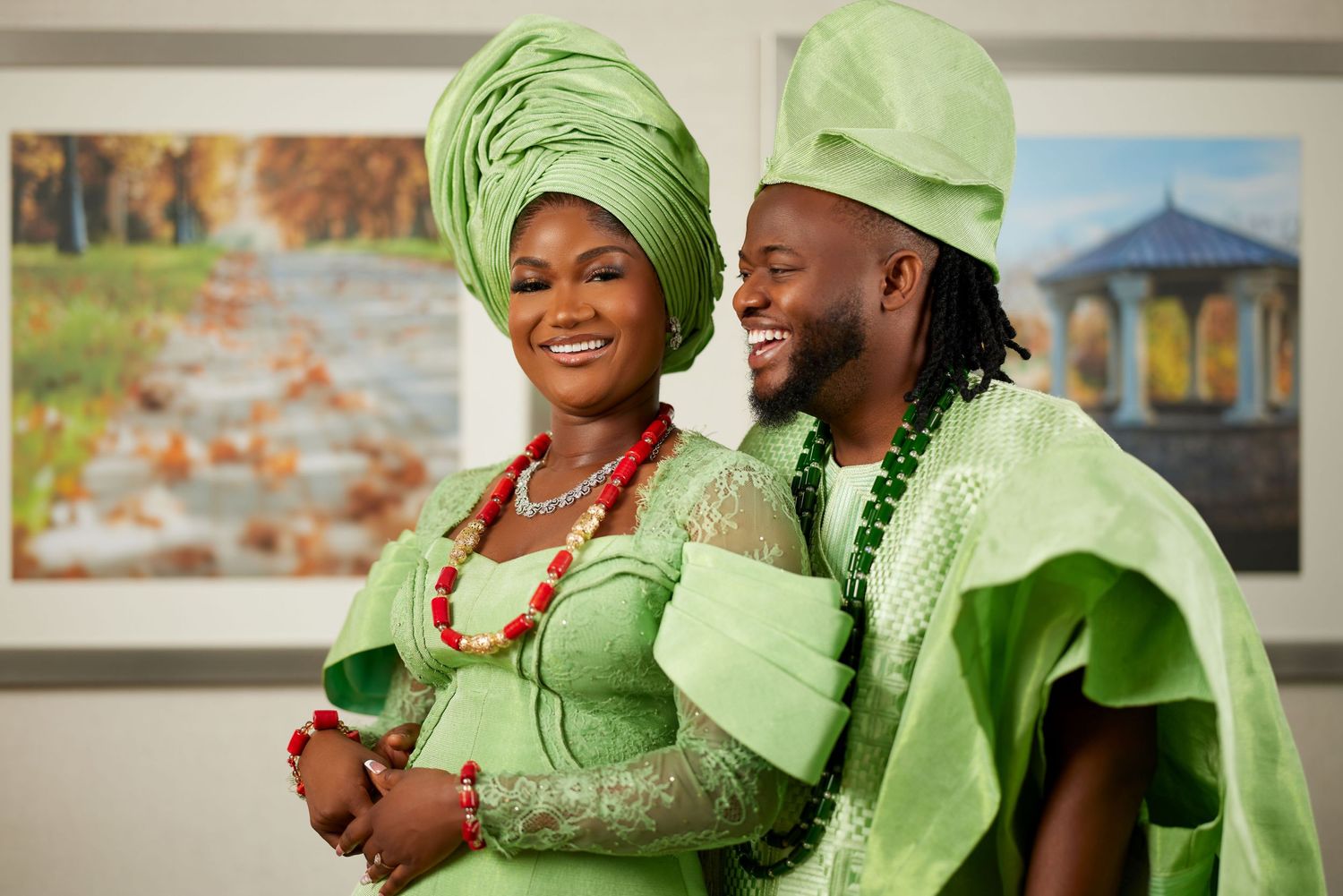 Wedding guests wearing vibrant green traditional attire celebrate joyfully during a festive celebration.
