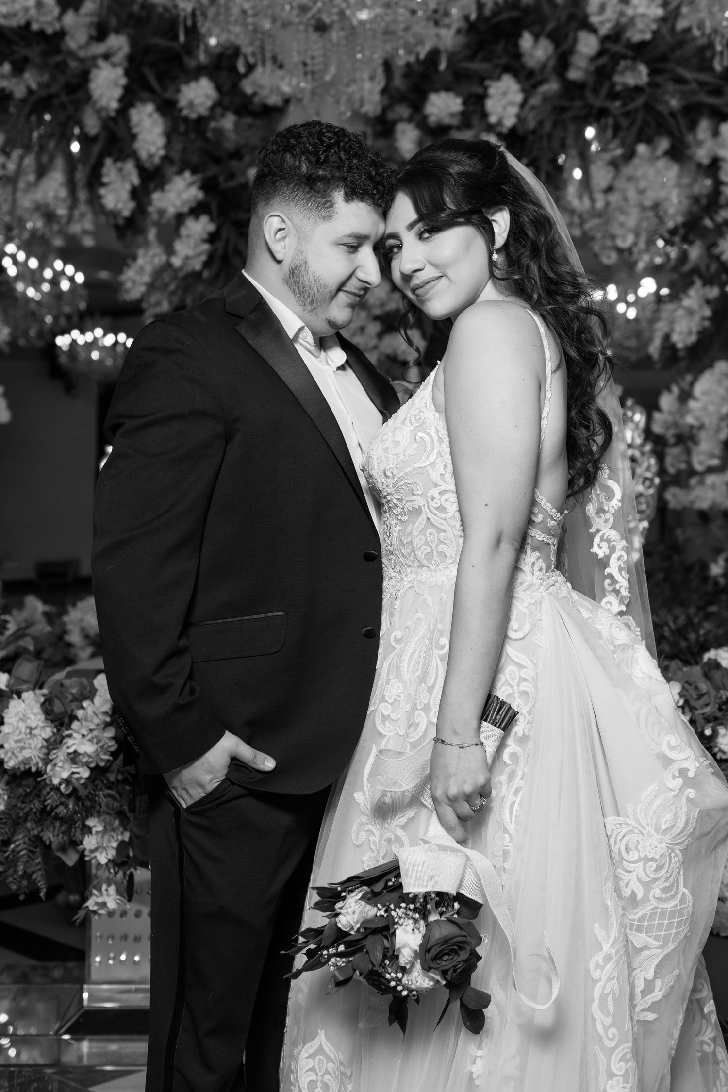 A traditional church wedding ceremony with a couple standing at the altar under a wooden arch.