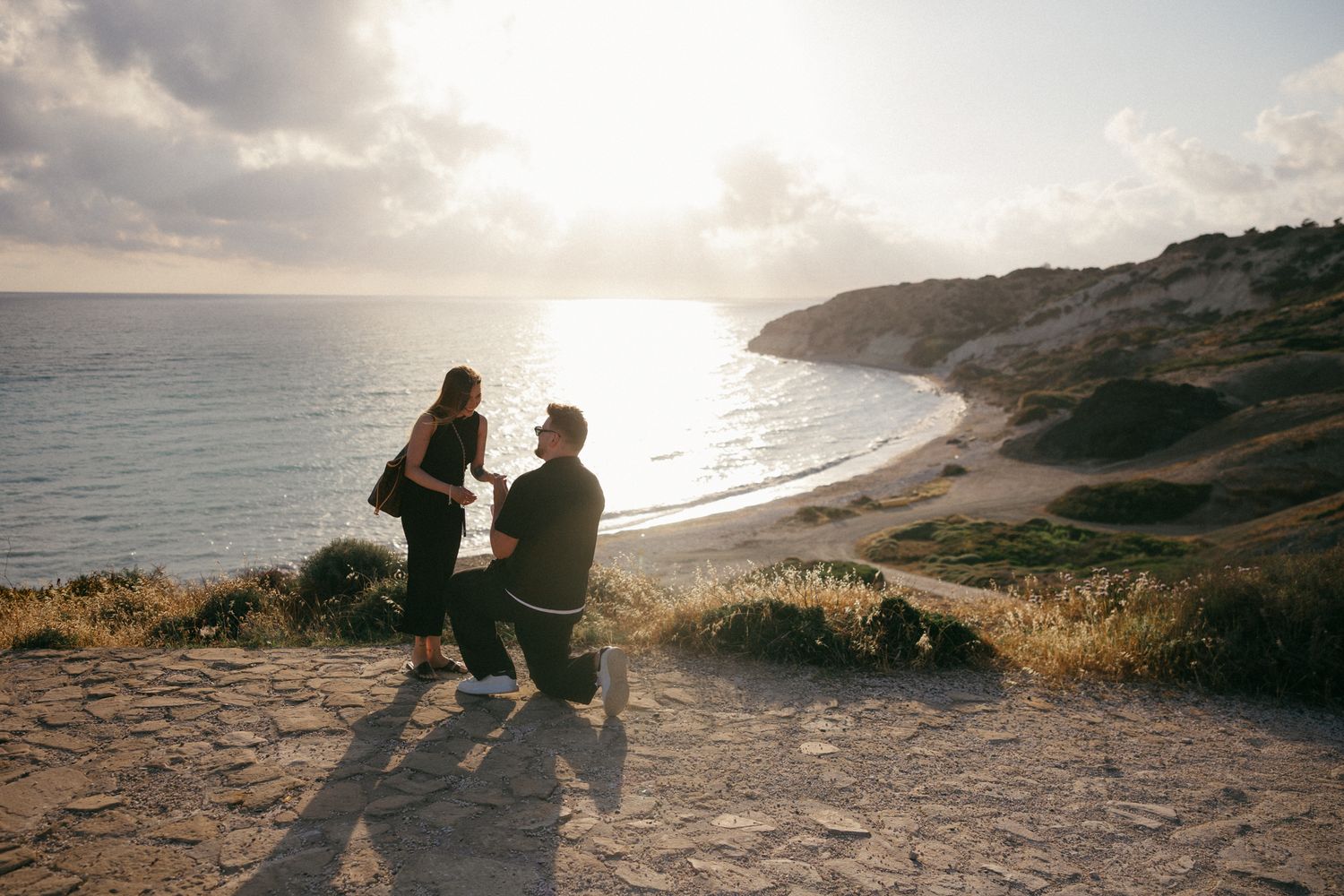 Couple getting engaged on the beach in Paphos, captured by professional photographers with over 10 years of experience.